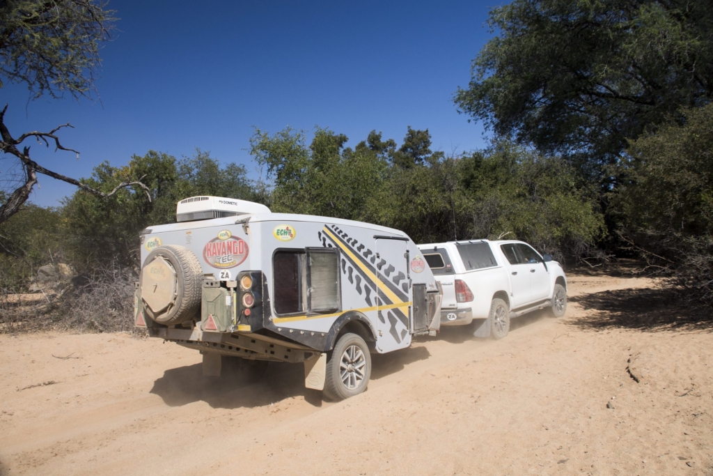 Echo Kavango Tec caravan being towed through deep sand on a rugged 4x4 adventure trail
