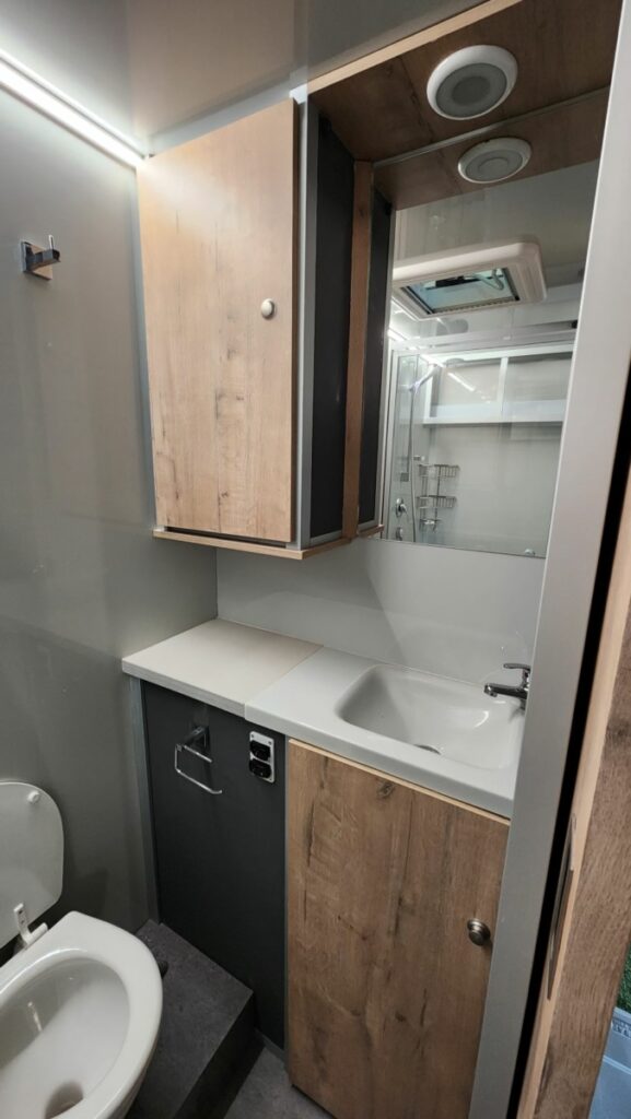Inside the bathroom of a luxury caravan showing the toilet.